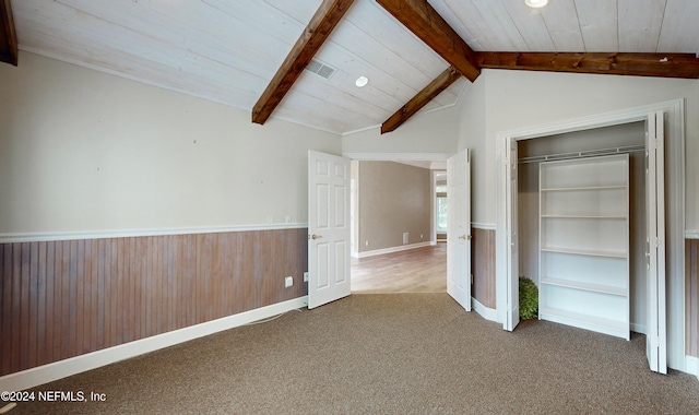 unfurnished bedroom featuring vaulted ceiling with beams, wood walls, and wood ceiling