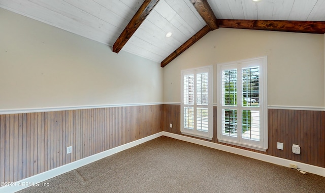 unfurnished room with carpet flooring, vaulted ceiling with beams, and wood walls