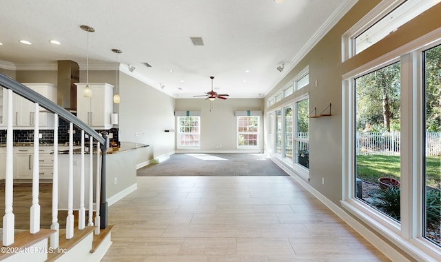 interior space featuring a wealth of natural light and ornamental molding