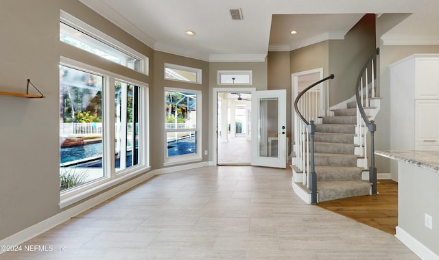 entryway featuring ceiling fan, light wood-type flooring, and ornamental molding