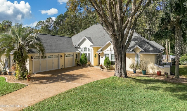 view of front of home featuring a front yard and a garage