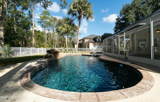 view of pool with glass enclosure