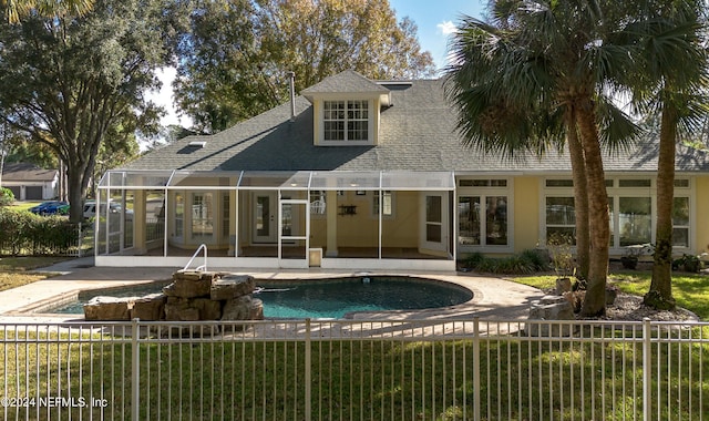 back of house with a fenced in pool, a yard, and a patio