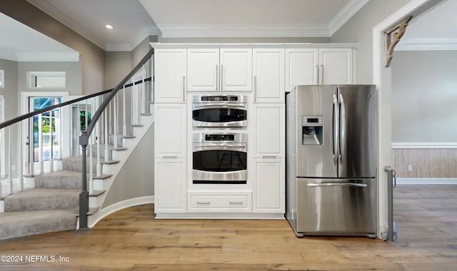 kitchen with crown molding, white cabinetry, light hardwood / wood-style flooring, and stainless steel appliances