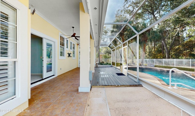 view of swimming pool featuring glass enclosure and a patio area