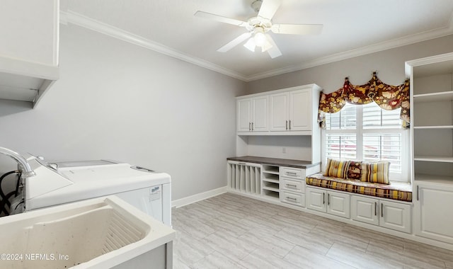 clothes washing area with separate washer and dryer, ceiling fan, cabinets, and ornamental molding