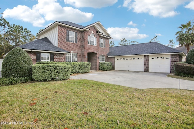 view of front facade with a garage and a front lawn