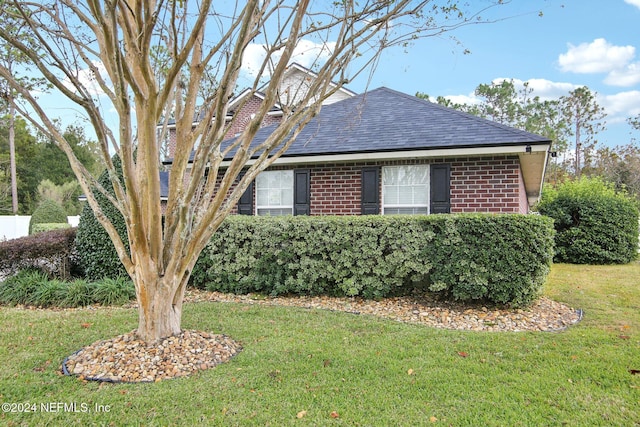 view of property exterior with a yard