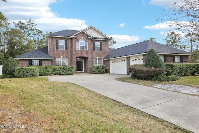 view of front of house featuring a front yard and a garage