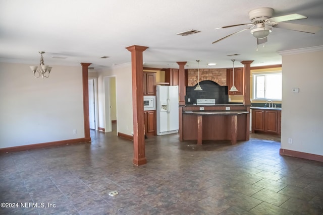 kitchen featuring white appliances, visible vents, ornate columns, a sink, and crown molding