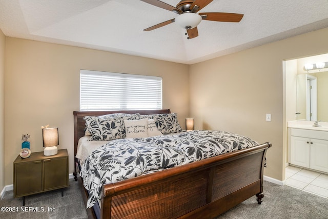 bedroom with connected bathroom, ceiling fan, sink, a textured ceiling, and light carpet