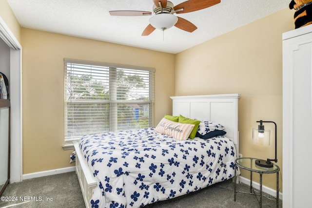 carpeted bedroom with a textured ceiling and ceiling fan