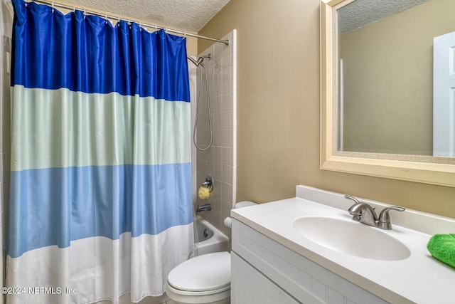 full bathroom with vanity, toilet, a textured ceiling, and shower / tub combo