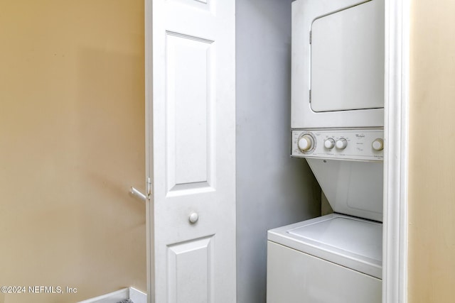 clothes washing area featuring stacked washer and clothes dryer