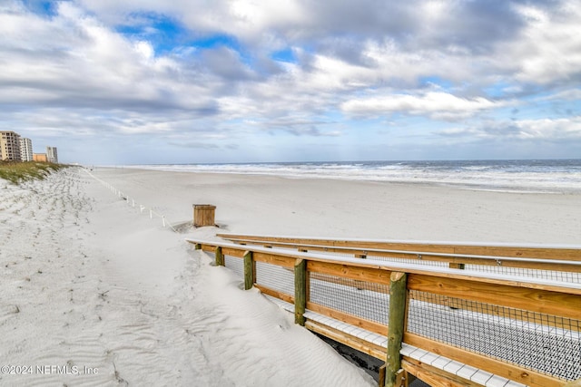 dock area featuring a beach view and a water view