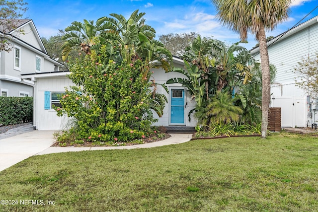 obstructed view of property featuring a front yard