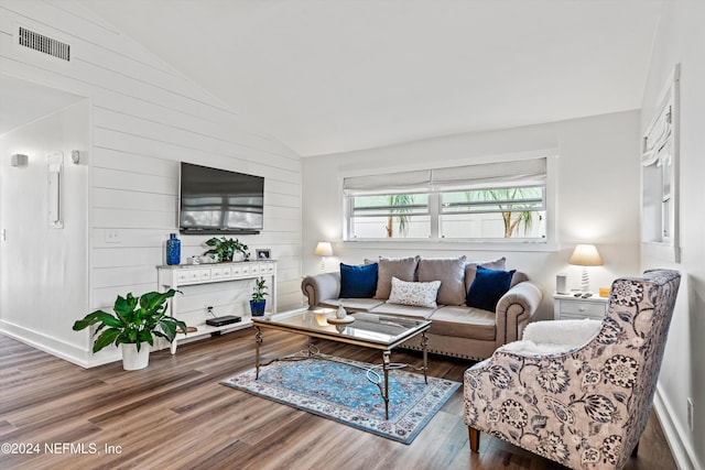 living room featuring hardwood / wood-style flooring and vaulted ceiling