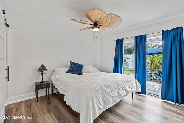 bedroom with hardwood / wood-style floors, ceiling fan, and access to outside