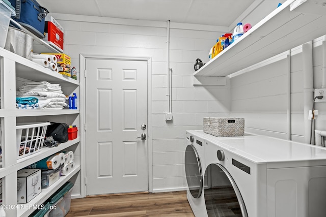 clothes washing area featuring dark wood-type flooring and washing machine and clothes dryer