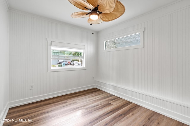 unfurnished room with hardwood / wood-style flooring, ceiling fan, and ornamental molding