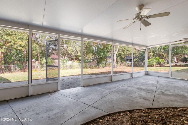 unfurnished sunroom with ceiling fan and a healthy amount of sunlight