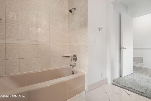 bathroom featuring tile patterned flooring and tiled shower / bath