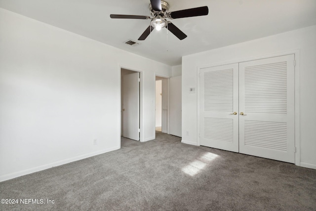 unfurnished bedroom featuring carpet flooring, ceiling fan, and a closet