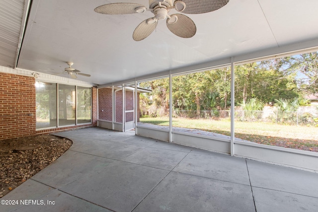 unfurnished sunroom with ceiling fan