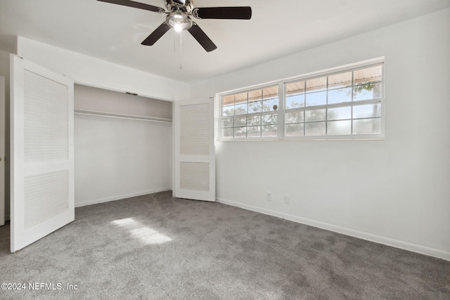 unfurnished bedroom featuring multiple windows, carpet flooring, ceiling fan, and a closet