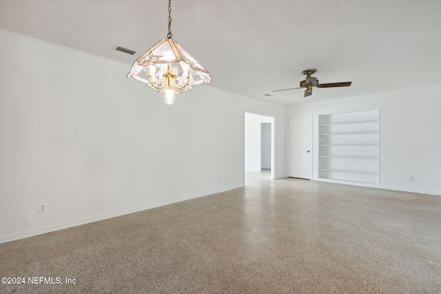 spare room with ornamental molding, ceiling fan, and built in shelves