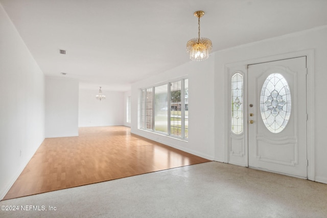 foyer entrance with wood-type flooring and a notable chandelier