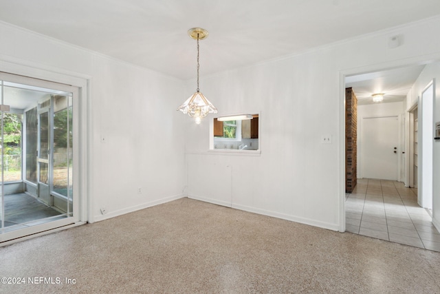 spare room with an inviting chandelier and ornamental molding