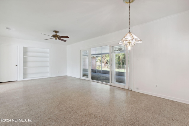 spare room featuring ceiling fan and built in features