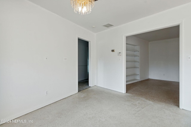 empty room featuring a chandelier