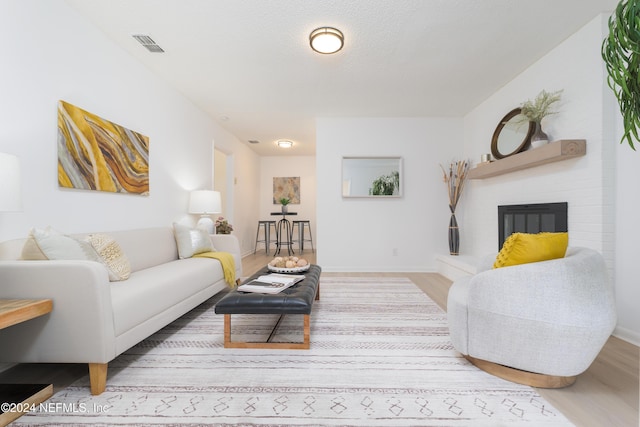 living room featuring a fireplace and hardwood / wood-style floors