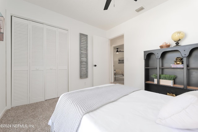 carpeted bedroom featuring ceiling fan, a textured ceiling, and a closet