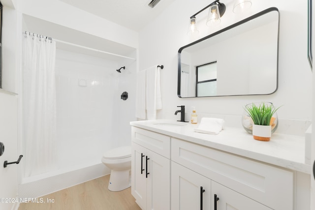 bathroom featuring vanity, curtained shower, toilet, and wood-type flooring