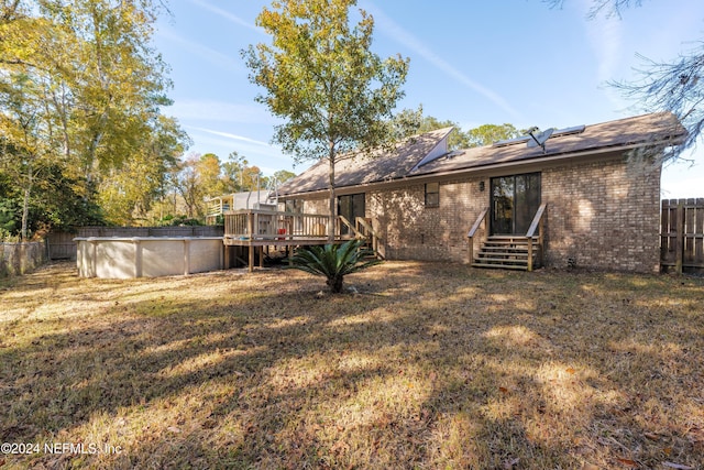 view of yard with a swimming pool side deck