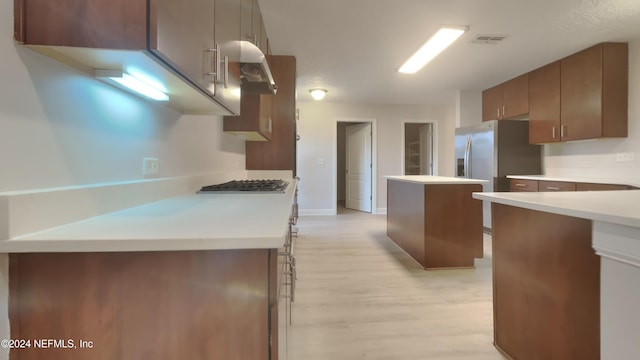 kitchen with light wood-type flooring and appliances with stainless steel finishes