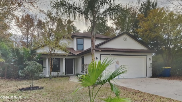 view of front of house featuring a front lawn and a garage