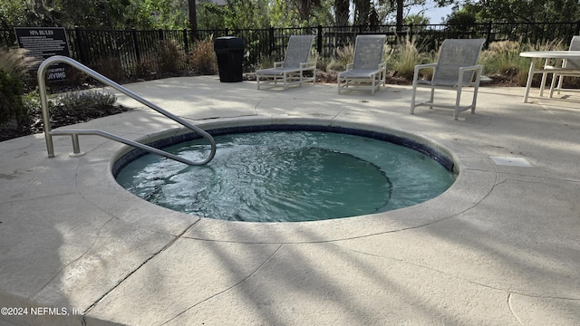 view of swimming pool featuring a patio area and a hot tub