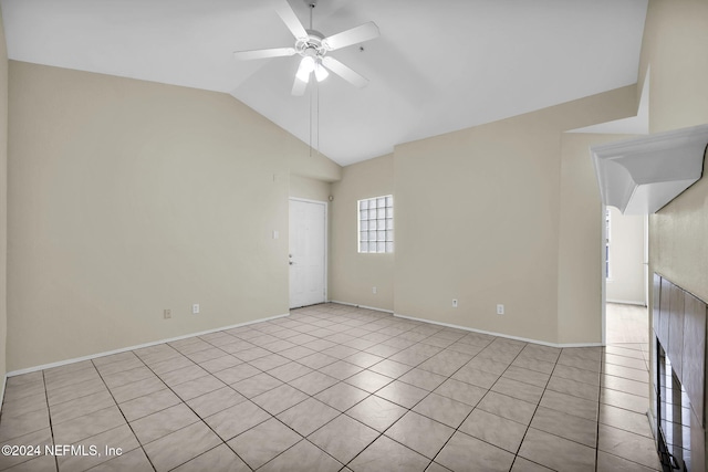 tiled spare room with vaulted ceiling and ceiling fan