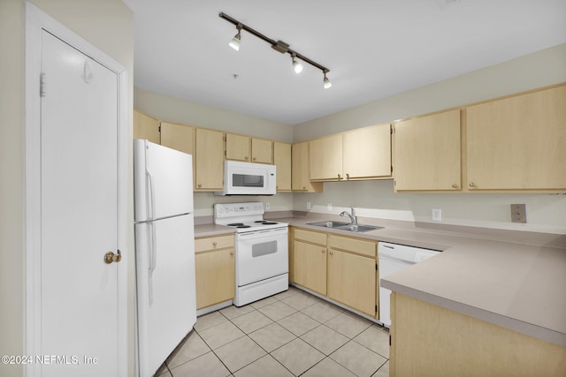 kitchen with sink, light tile patterned flooring, white appliances, and light brown cabinets