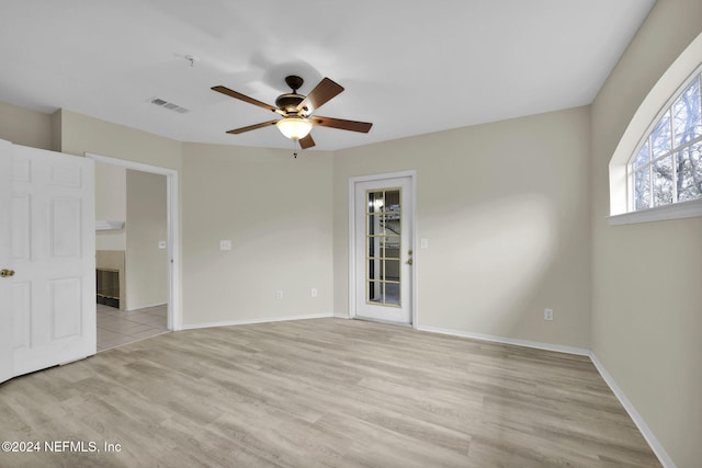 spare room with light hardwood / wood-style floors and ceiling fan