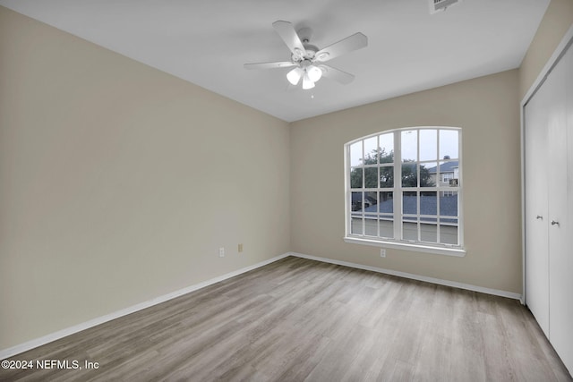 spare room featuring light hardwood / wood-style floors and ceiling fan