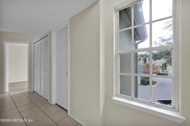 corridor featuring light tile patterned floors