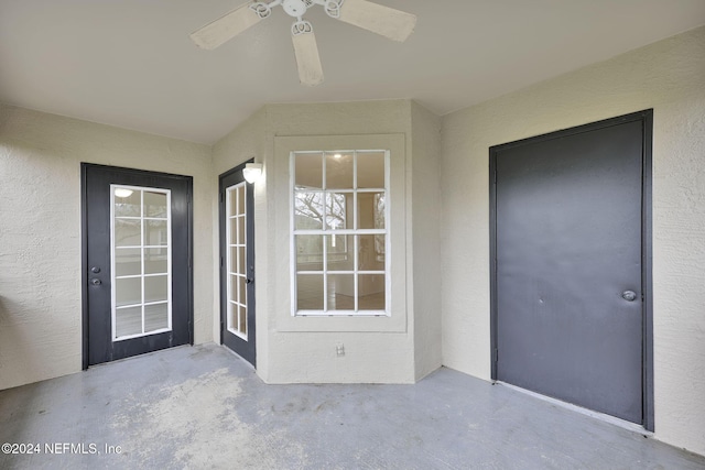 entrance to property featuring ceiling fan and a patio area