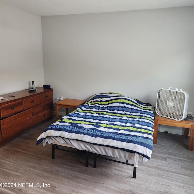 bedroom with wood-type flooring