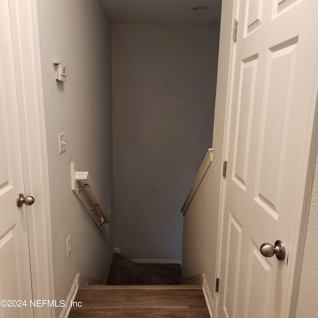 stairs featuring hardwood / wood-style floors