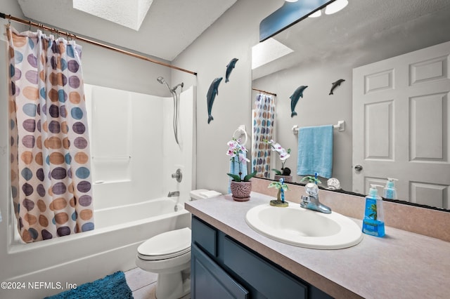 full bathroom with shower / bath combo, vanity, a skylight, tile patterned flooring, and toilet